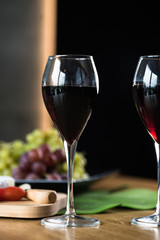Waiter pouring red wine into wineglass. 