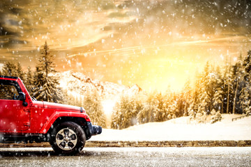 red winter car and snow flakes. Forest landscape and mountains. 