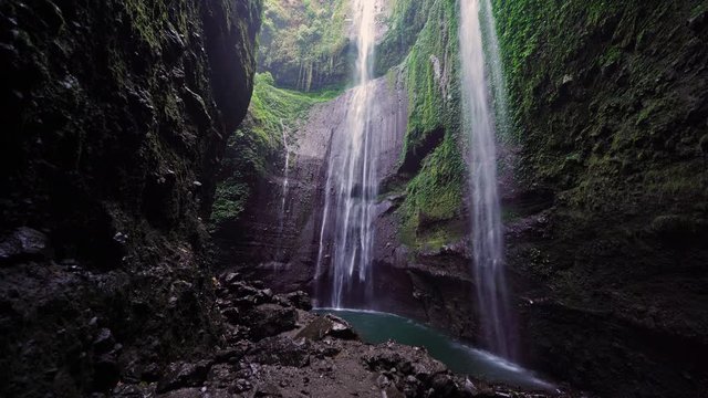 Madakaripura Waterfall in national park. The tallest waterfall in Java Island. Nature landscape background of travel trip and holidays vacation in Indonesia. Tourist attraction.