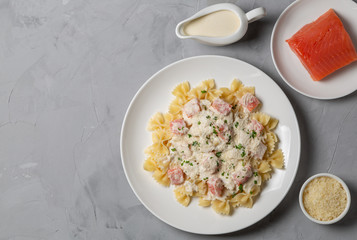 Pasta Farfalle with smoked salmon in cream sauce. The view from the top. Copy space.