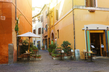 Fototapeta na wymiar Trastevere in Rome, Italy. Cozy old street in Trastevere neighborhood of Rome, on the west bank of the Tiber, architecture and landmark of the city of Rome.