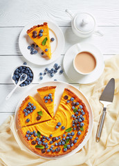 pumpkin tart decorated with berries, top view