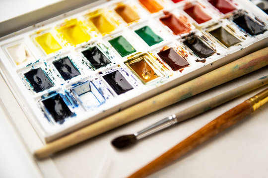 Set watercolor paints with paintbrush. Art concept