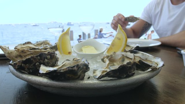 Friends share Fresh Oysters on Ice with Lemon, Cap Ferret, France 4
