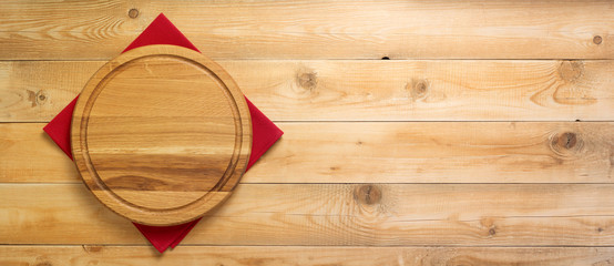 pizza cutting board and naplin at wooden background