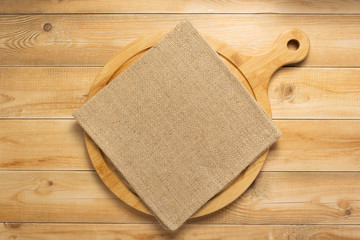 pizza cutting board and naplin at wooden background