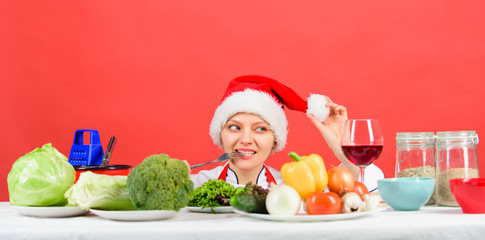 Healthy christmas holiday recipes. Woman chef or housewife cooking while wear santa hat. Best...