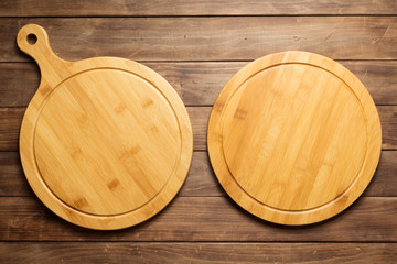 Fototapeta na wymiar pizza cutting board at wooden plank board background