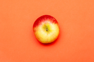 Apple on orange backdrop