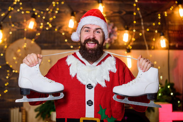 man santa hat. Christmas interior. happy man skates. new year gifts. christmas decoration. santa...