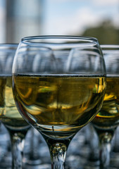 Close up view of transparent glasses with champagne wine lined up symmetrically 