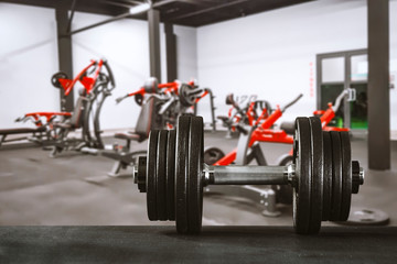 Gym interior and dumbbells on board with free space for your decoration. 