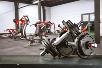 Gym interior and dumbbells on board with free space for your decoration. 