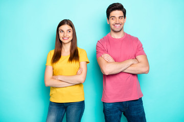 Portrait of his he her she nice attractive lovely charming cute cheerful cheery shy couple looking at each other folded arms isolated over bright vivid shine vibrant green turquoise background