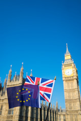 European Union and British Union Jack flag flying together in front of Big Ben and the Houses of Parliament at Westminster Palace, London as the UK Brexit process progresses © lazyllama