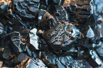 Close-up of black shiny mineral and crystal stone.