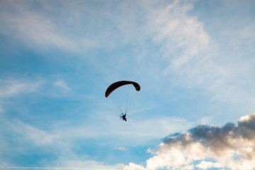 silhouette of skydiver with parachute - live your dream, freedom and adrenaline concept