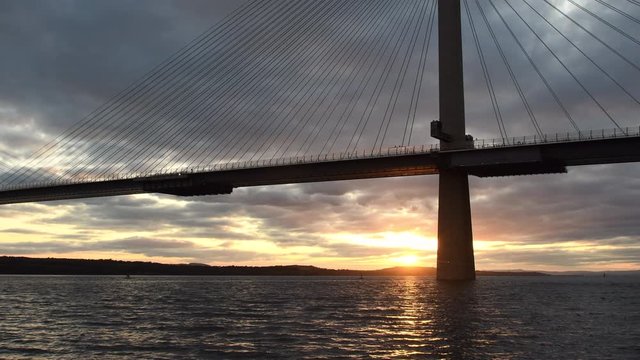 4K Video of sunset in North Queensferry near Edinburgh and Queensferry Crossing Bridge. North Queensferry is located ten miles west of the center of Edinburgh in Scotland. Full hd video.