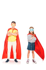 full length view of two kids in hero cloaks standing with crossed arms on white