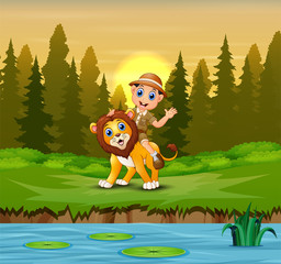 Happy zookeeper man with a lion in the jungle