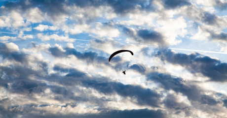 silhouette of skydiver with parachute - live your dream, freedom and adrenaline concept