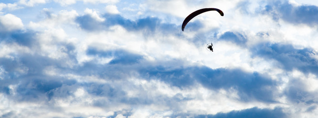 silhouette of skydiver with parachute - live your dream, freedom and adrenaline concept