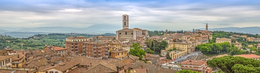 Fototapeta na wymiar Perugia is a lively medieval walled hill town.Panoramic view of Perugia with basilica of San Domenico and with historic buildings, Umbria, Italy