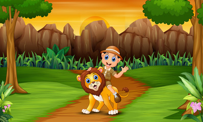 Happy zookeeper man with a lion in the jungle
