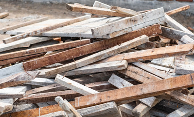 Pile of timber wood used for scaffolding and structure in house building construction in Thailand.