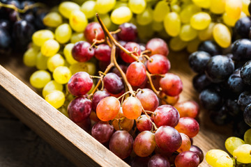 Ripe different sorts of grape on the rustic background. Selective focus. Shallow depth of field.