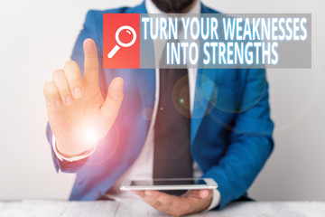 Writing note showing Turn Your Weaknesses Into Strengths. Business concept for work on your defects to get raid of them Businessman with pointing finger in front of him