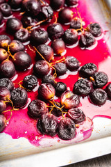 Roasted black grape on the rustic background. Selective focus. Shallow depth of field.