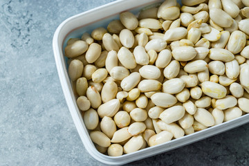 Organic Unsalted White Peeled Raw Peanuts in Plastic Box Container / Package.