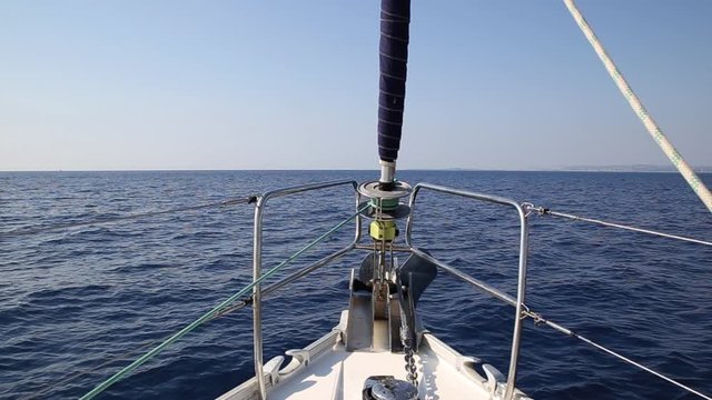 Sailboat in the open ocean on a cloudless day
