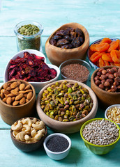 nuts, seeds and dried fruis on wooden surface