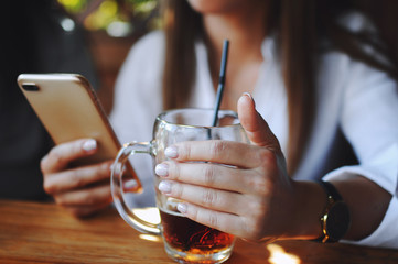 Girl holding a glass of beer with a tube