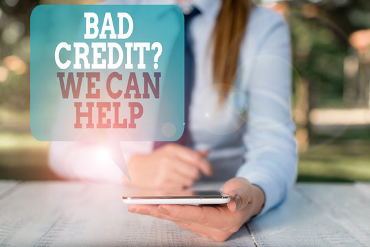 Writing note showing Bad Credit Question We Can Help. Business concept for Borrower with high risk Debts Financial Female business person sitting by table and holding mobile phone