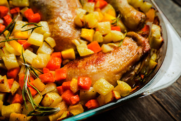 Autumn foodie, roasted chicken with pumpkin, carrots, potatoes and spices in glass pan. Selective focus. Shallow depth of fied.