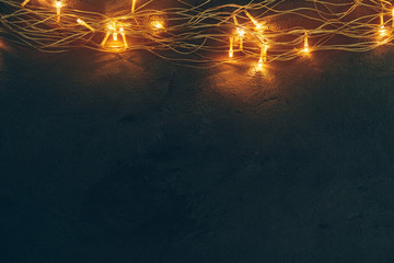 Warm light illuminated garland close up on dark background