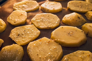 Roasting Potato on the Grill. Golden Slices Seasoned with Spices.