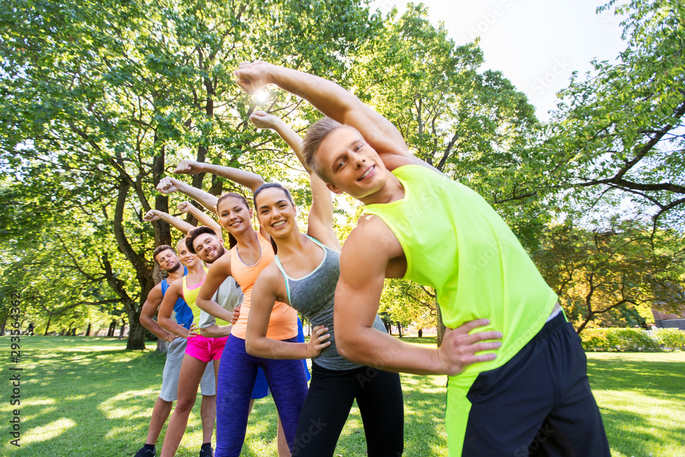 Sticker fitness, sport and healthy lifestyle concept - group of happy people exercising at summer park or bo