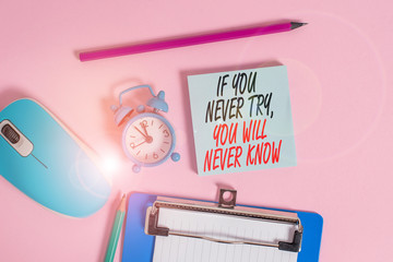 Conceptual hand writing showing If You Never Try You Will Never Know. Concept meaning Inspiration to make new thing Alarm clock notepad clipboard paper markers color background