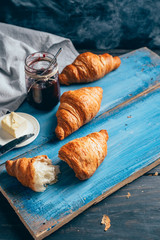 delicious croissants on blue wooden table
