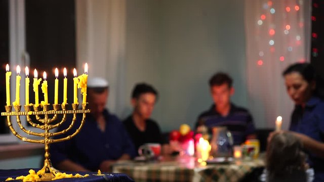 Hanukkah Night. A Holiday Dinner Party With Friends and Family. Jewish Family Eating Kosher Meals At Home