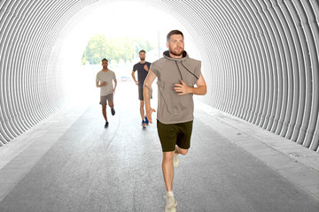 fitness, sport and healthy lifestyle concept - young men or male friends running outdoors