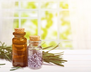 Herbal oil in bottle on wooden table
