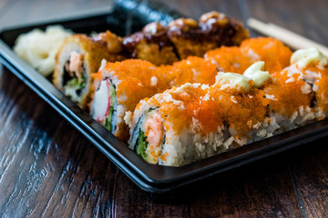 Sushi Set in Plastic Container Box / Package. California Roll, New York Roll, Boom Roll, Ginger, Wasabi and Soy Sauce.