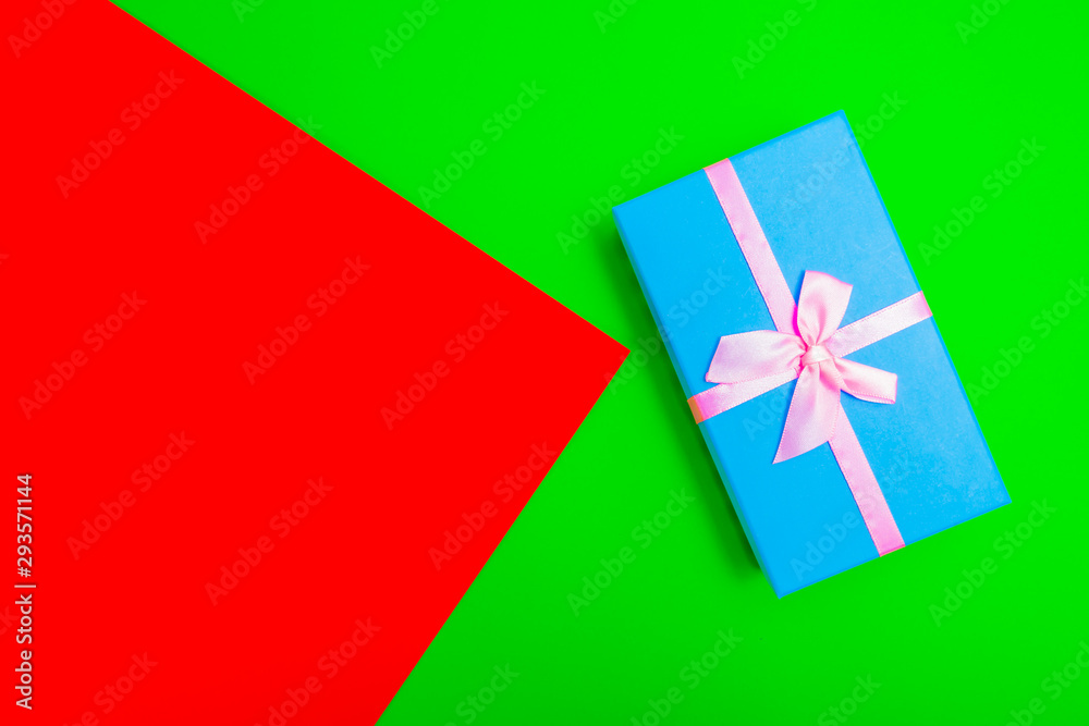 Poster gift box with ribbon on a colorful background. view from above.
