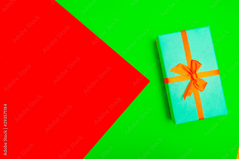 Poster gift box with ribbon on a colorful background. view from above.