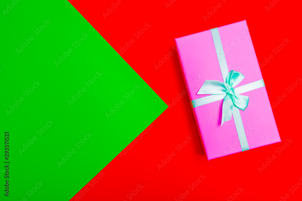 Poster gift box with ribbon on a colorful background. view from above.